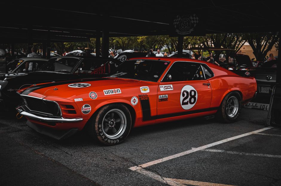 A classic red Ford Mustang racecar on display outdoors in Tulsa, Oklahoma.